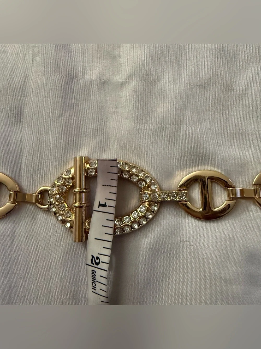 Gold tone metal chain belt with rhinestone details